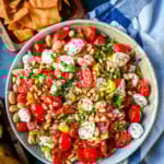 This Italian Cowboy Caviar is a fresh, flavorful twist on the viral cowboy caviar made with juicy tomatoes, creamy mozzarella pearls, tender white beans, pepperoncinis, and basil for a Mediterranean-inspired dip. This easy Italian appetizer comes together in minutes and is perfect for holiday parties, snacking, or meal prep.