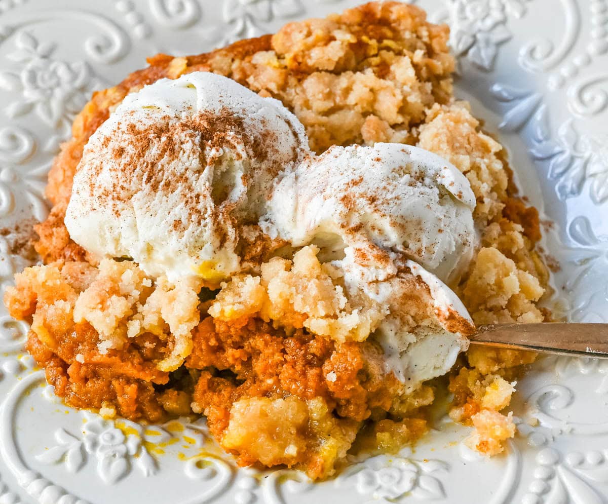This Pumpkin Cobbler recipe is made with a creamy, rich spiced pumpkin filling and then topped with a sweet, buttery crumble. This Pumpkin Crisp recipe is so easy to make! An easy Fall and Thanksgiving dessert.