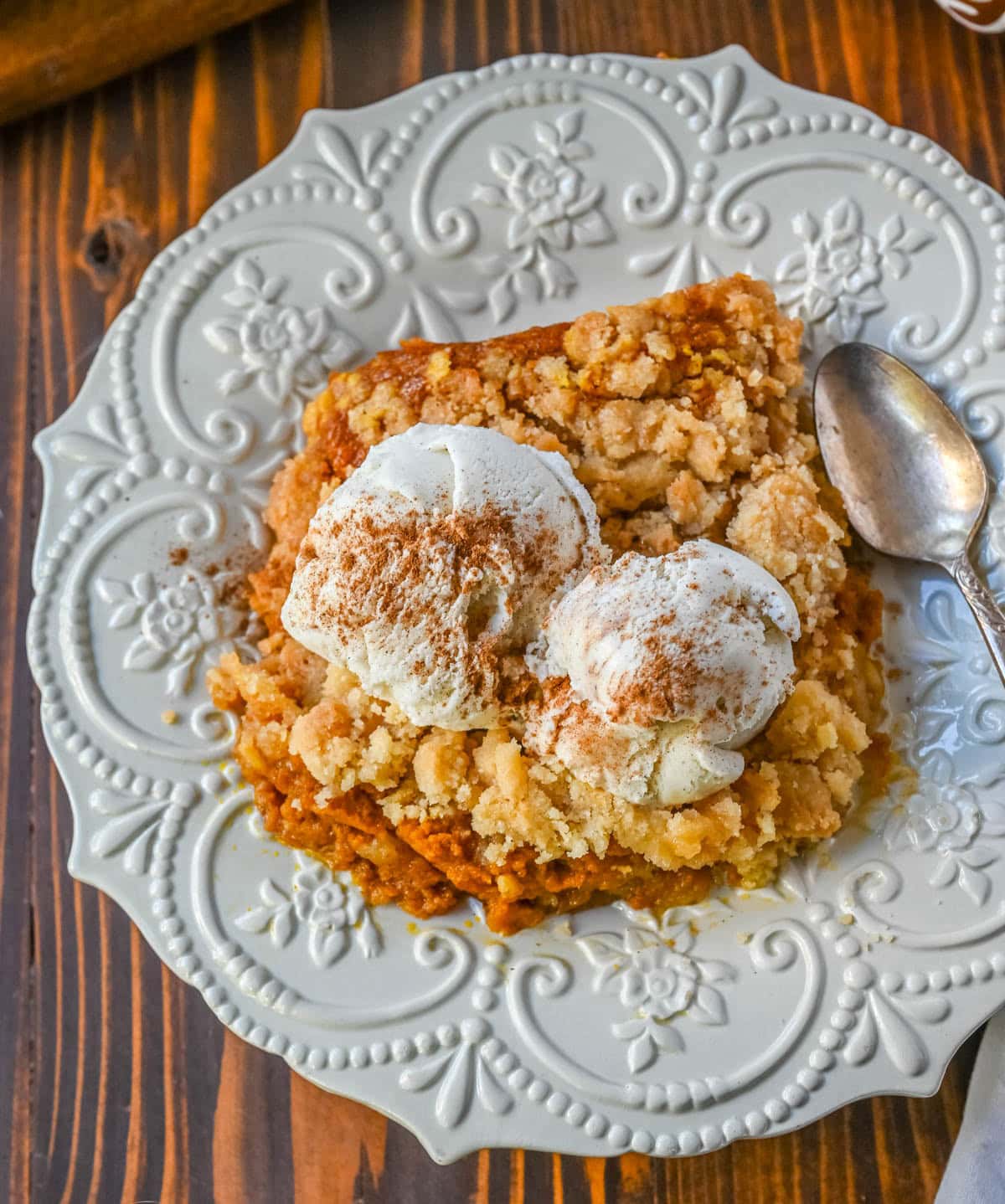 This Pumpkin Cobbler recipe is made with a creamy, rich spiced pumpkin filling and then topped with a sweet, buttery crumble. This Pumpkin Crisp recipe is so easy to make! An easy Fall and Thanksgiving dessert.