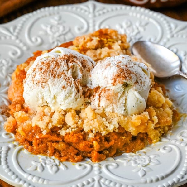 This Pumpkin Cobbler recipe is made with a creamy, rich spiced pumpkin filling and then topped with a sweet, buttery crumble. This Pumpkin Crisp recipe is so easy to make! An easy Fall and Thanksgiving dessert.