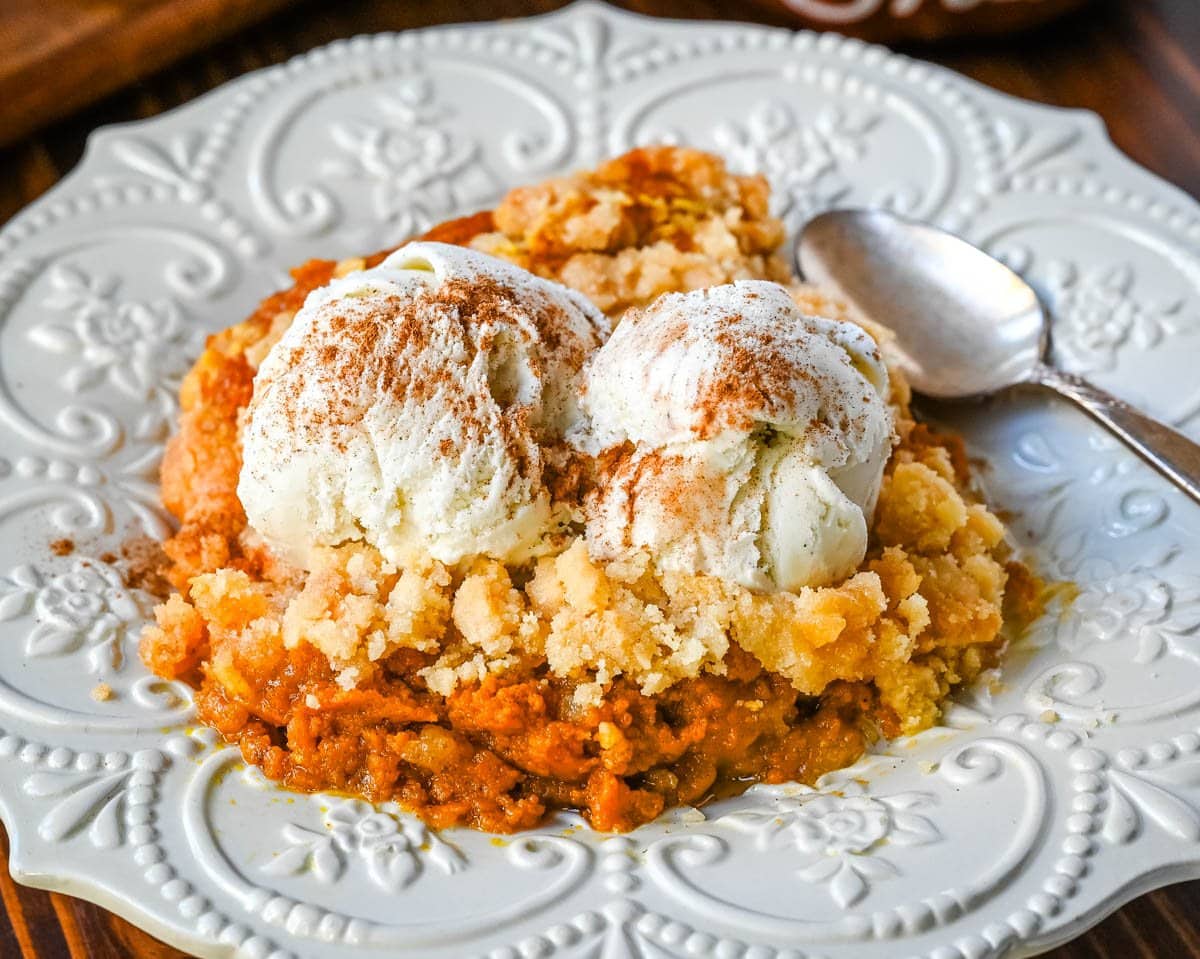 This Pumpkin Cobbler recipe is made with a creamy, rich spiced pumpkin filling and then topped with a sweet, buttery crumble. This Pumpkin Crisp recipe is so easy to make! An easy Fall and Thanksgiving dessert.