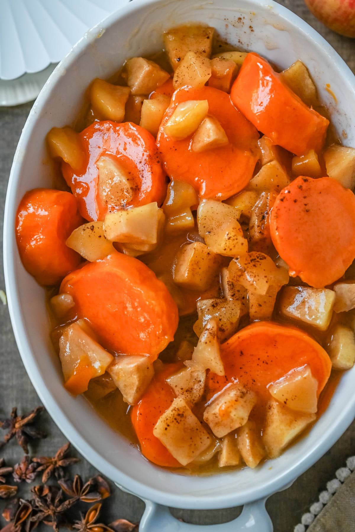 Tender sweet potatoes and apples layered in a silky butter and sugar sauce that thickens into a shiny glaze as it bakes. A timeless fall side dish everyone will love.