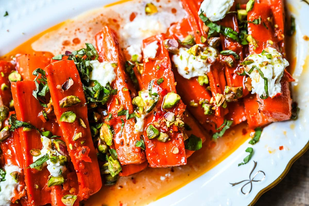 These Sweet and Spicy Roasted Carrots are the perfect combination of sweetness and a warm kick from the Calabrian chili paste. Topped with creamy burrata, crunchy pistachios, and fresh basil, this side dish feels restaurant-worthy but is incredibly easy to make at home. The best roasted carrot side dish recipe!