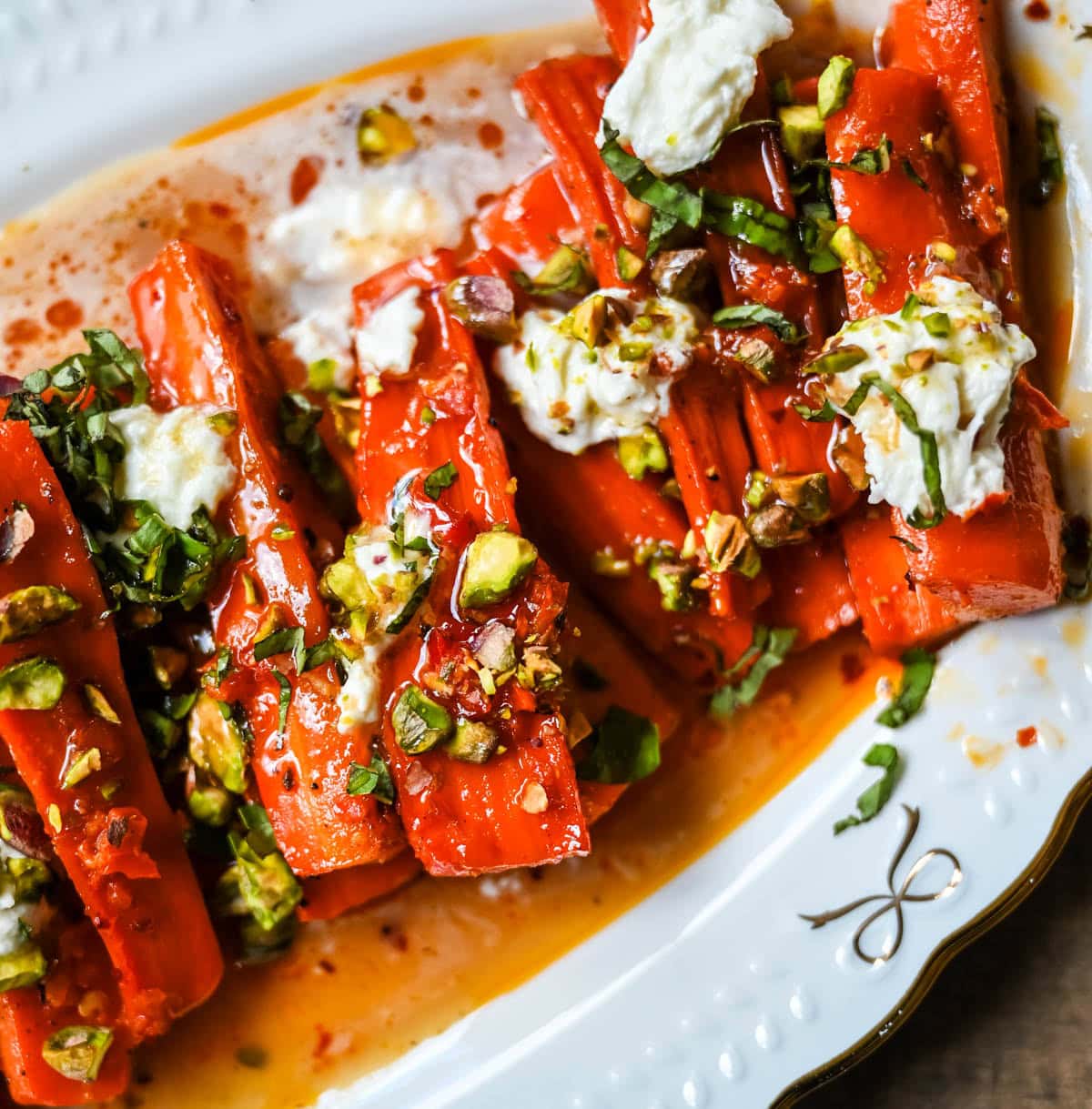 These Sweet and Spicy Roasted Carrots are the perfect combination of sweetness and a warm kick from the Calabrian chili paste. Topped with creamy burrata, crunchy pistachios, and fresh basil, this side dish feels restaurant-worthy but is incredibly easy to make at home. The best roasted carrot side dish recipe!