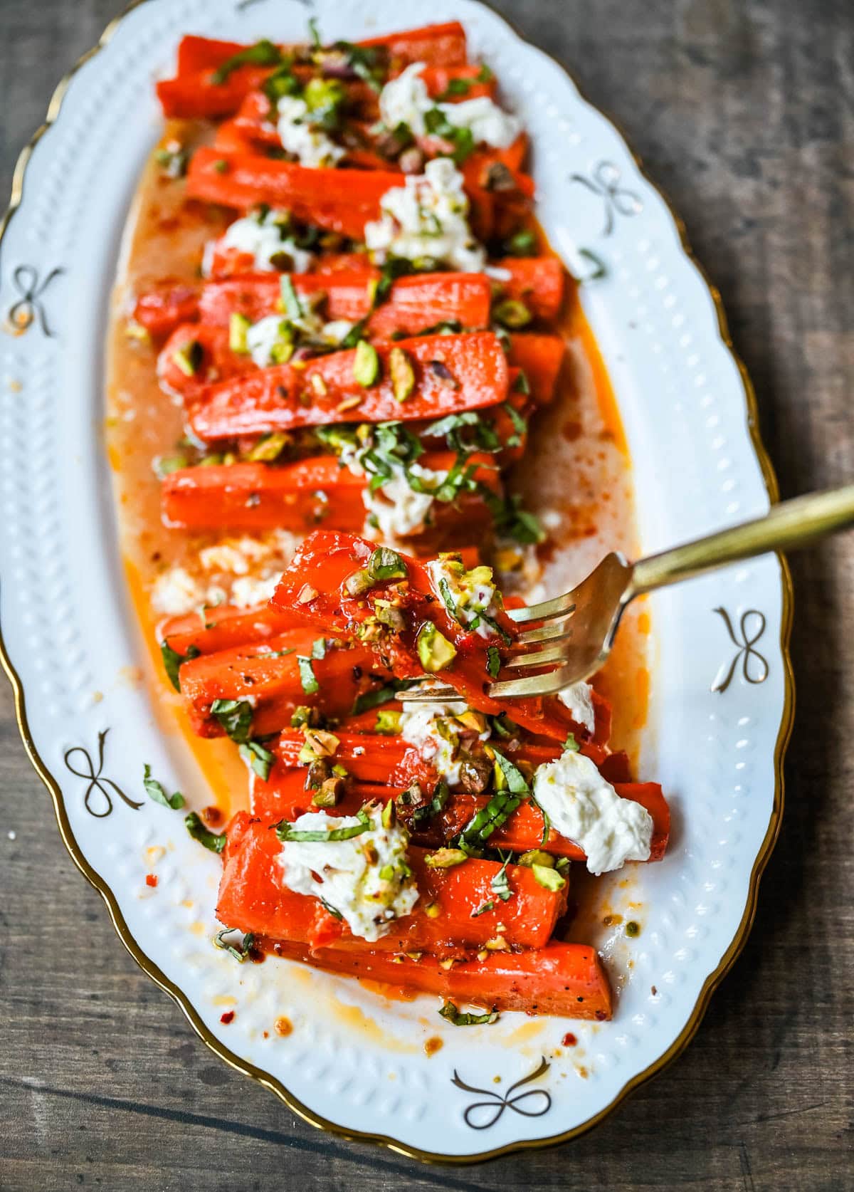 These Sweet and Spicy Roasted Carrots are the perfect combination of sweetness and a warm kick from the Calabrian chili paste. Topped with creamy burrata, crunchy pistachios, and fresh basil, this side dish feels restaurant-worthy but is incredibly easy to make at home. The best roasted carrot side dish recipe!
