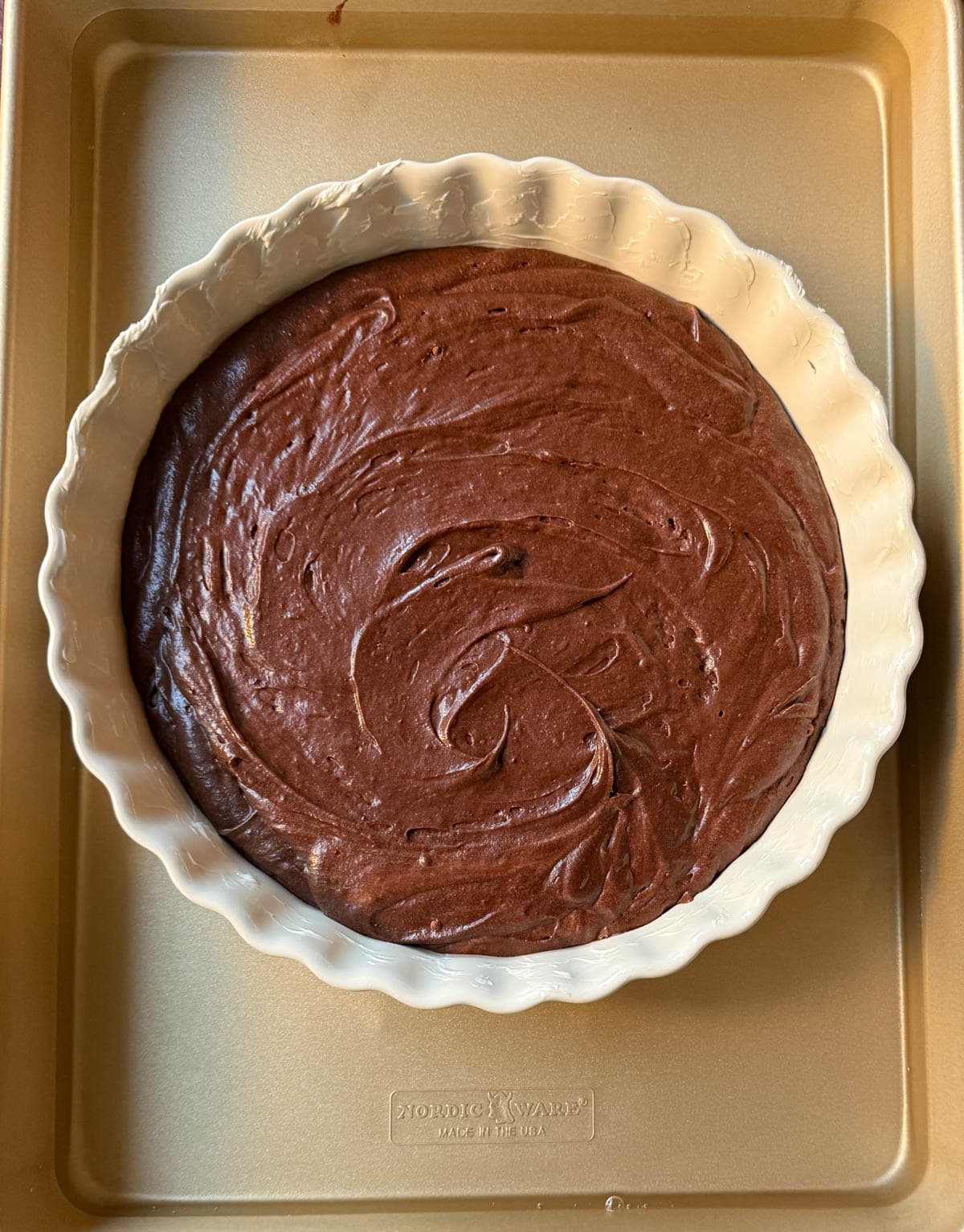 Ina Garten chocolate brownie pudding batter in pan and water bath before baking.
