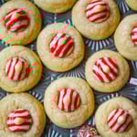 These Candy Cane Kiss Cookies are soft, buttery sugar cookies rolled in sparkling sugar or festive sprinkles, baked until just set, and then pressed with a striped peppermint Candy Cane Kiss right in the center. This Peppermint Kiss Cookie is such a festive Christmas cookie recipe.