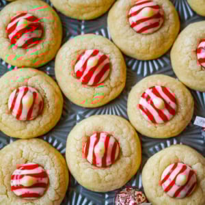 These Candy Cane Kiss Cookies are soft, buttery sugar cookies rolled in sparkling sugar or festive sprinkles, baked until just set, and then pressed with a striped peppermint Candy Cane Kiss right in the center. This Peppermint Kiss Cookie is such a festive Christmas cookie recipe.