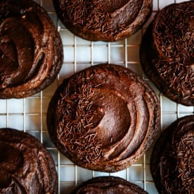 These easy Chocolate Frosted Cookies combine soft chocolate cookies with a rich, chocolate buttercream frosting. The double chocolate cookie base is filled with melty chocolate chips and a smooth cocoa frosting on top. These Frosted Chocolate Cookies are a chocolate lover’s dream.