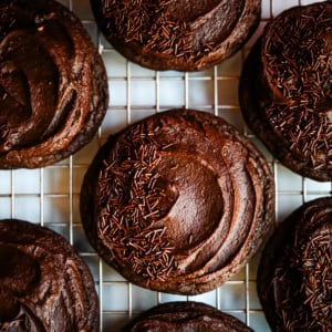 These easy Chocolate Frosted Cookies combine soft chocolate cookies with a rich, chocolate buttercream frosting. The double chocolate cookie base is filled with melty chocolate chips and a smooth cocoa frosting on top. These Frosted Chocolate Cookies are a chocolate lover’s dream.