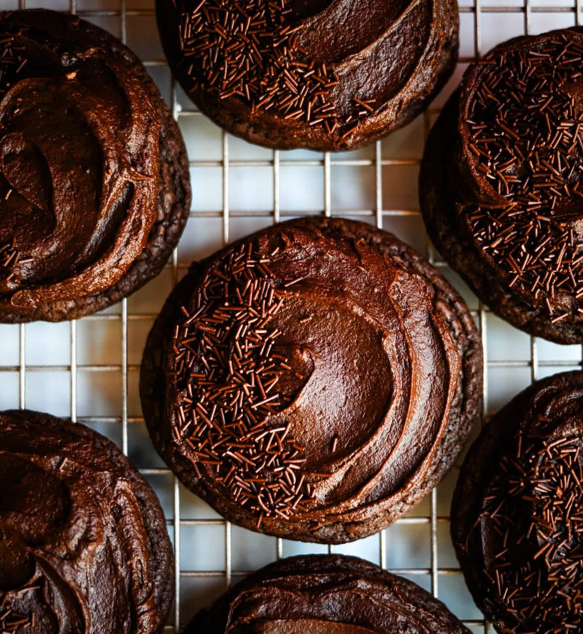 These easy Chocolate Frosted Cookies combine soft chocolate cookies with a rich, chocolate buttercream frosting. The double chocolate cookie base is filled with melty chocolate chips and a smooth cocoa frosting on top. These Frosted Chocolate Cookies are a chocolate lover’s dream.