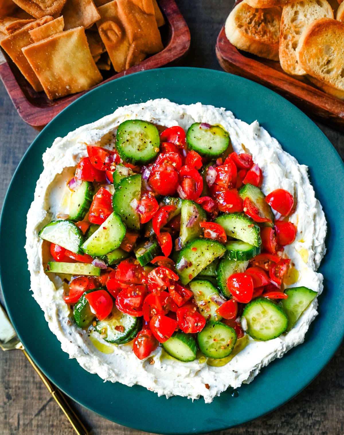 This Greek feta dip is the ultimate party and holiday appetizer that is rich, creamy, and so flavorful! It blends tangy feta, cream cheese, lemon, oregano, and olive oil into a silky whipped dip that feels fancy but takes just minutes to make. Pile it high with tomatoes, cucumbers, and a drizzle of olive oil, then serve with pita chips or veggies.