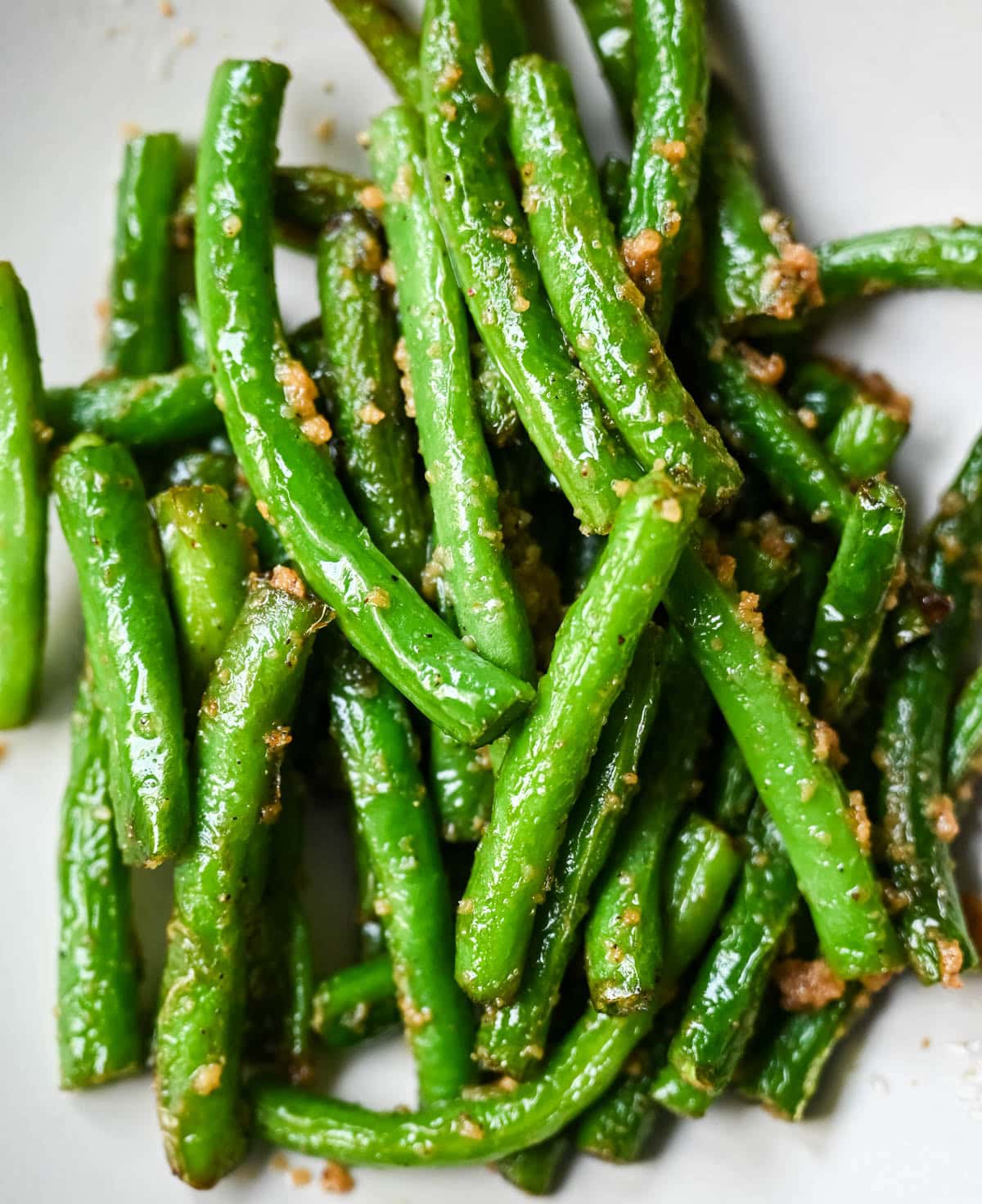 These Din Tai Fung green beans are crispy, blistered, and tossed with fresh garlic just like the famous restaurant version. A Chinese vegetable side dish that pairs perfectly with dumplings, noodles, or rice. The best copycat Din Tai Fung garlic green beans recipe!