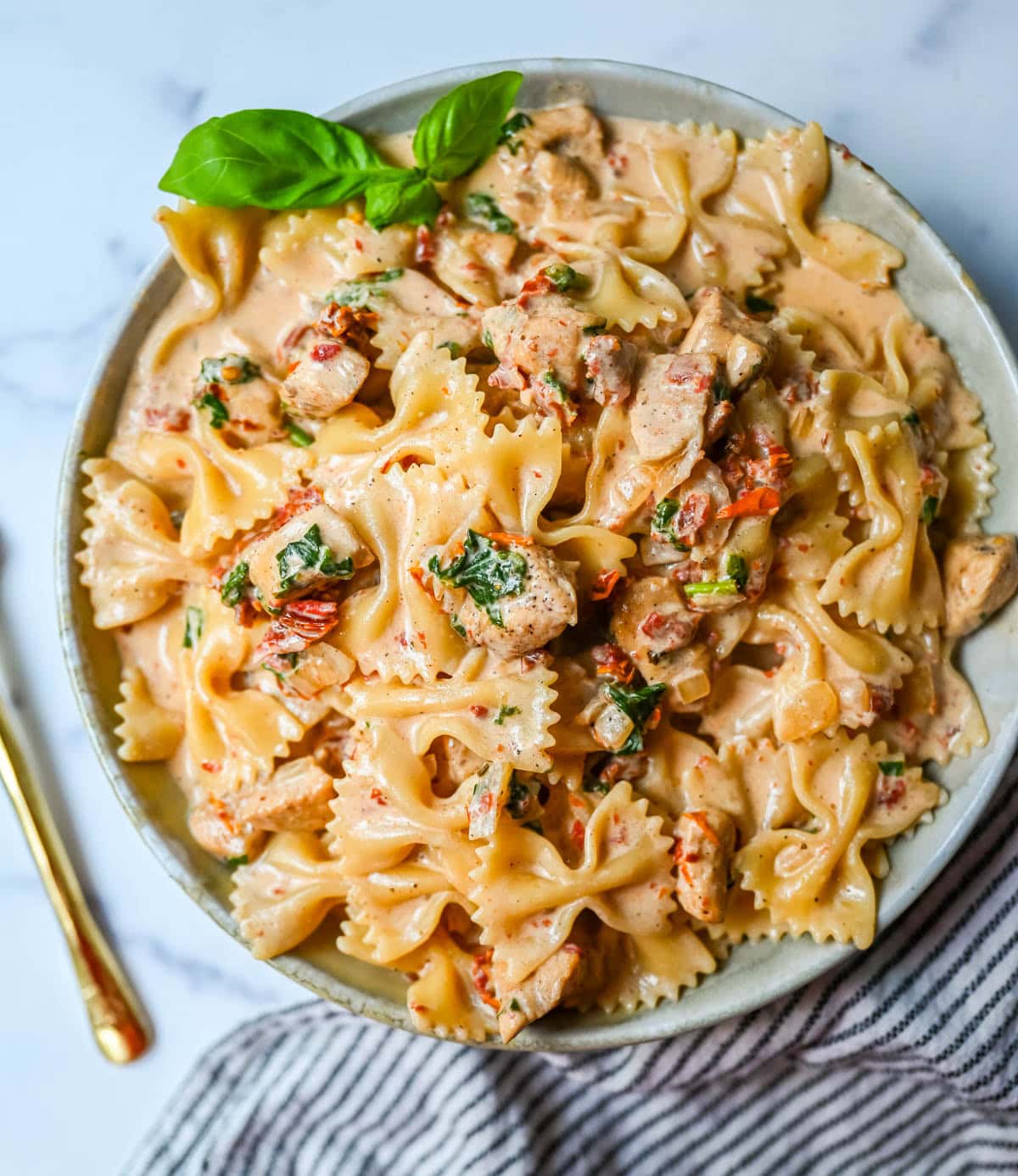 This Marry Me Chicken Pasta recipe features chicken, sun-dried tomatoes, heavy cream, parmesan cheese, and pasta in a rich, flavorful sauce. It’s a simple one-pan creamy chicken pasta that’s an easy dinner recipe!