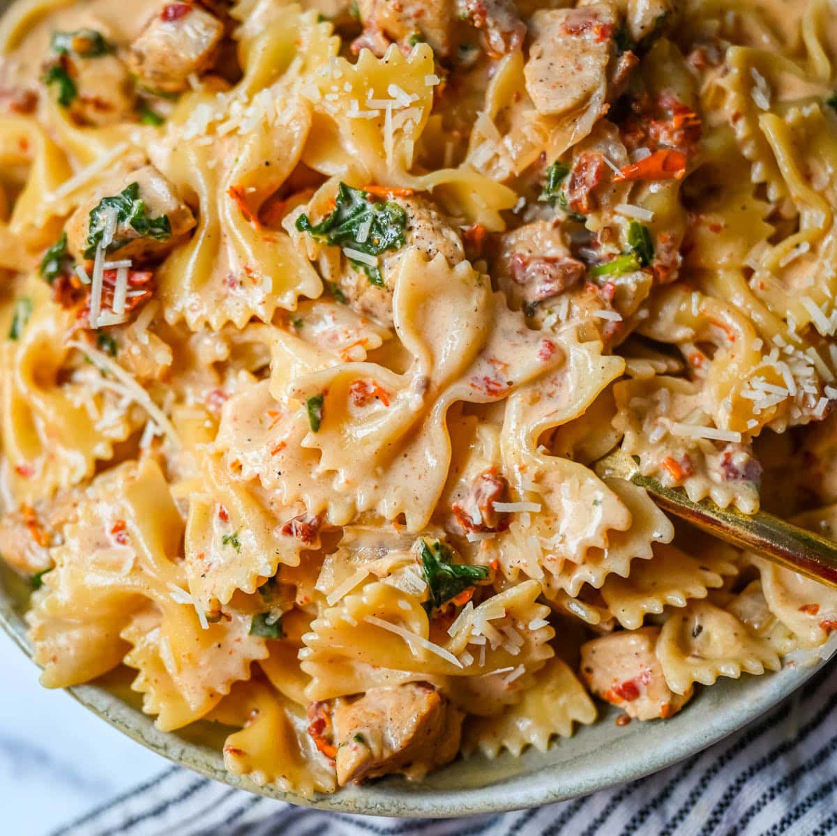 This Marry Me Chicken Pasta recipe features chicken, sun-dried tomatoes, heavy cream, parmesan cheese, and pasta in a rich, flavorful sauce. It’s a simple one-pan creamy chicken pasta that’s an easy dinner recipe!