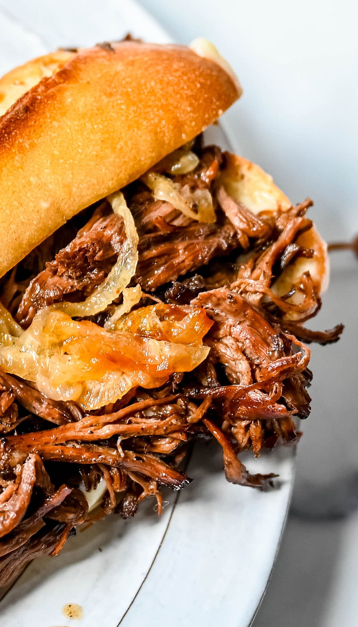 This easy slow cooker French dip sandwich recipe features tender beef, savory au jus, caramelized onions, and melted provolone cheese. Finished with a creamy horseradish aioli, it’s a restaurant-quality sandwich made right at home.