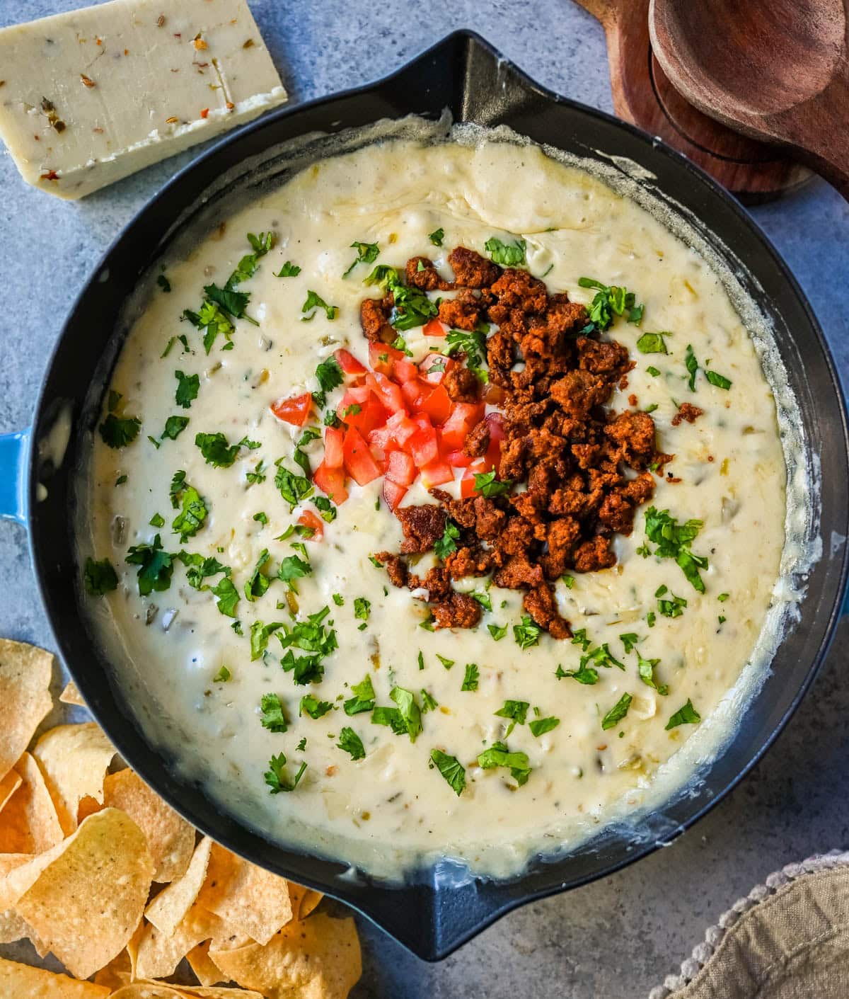 This creamy white queso dip is made with white American cheese, pepper jack, sautéed onion, garlic, and evaporated milk, it melts into the ultimate restaurant-style queso at home. The best rich easy queso recipe! I am sharing pro tips to keep it silky and never grainy.