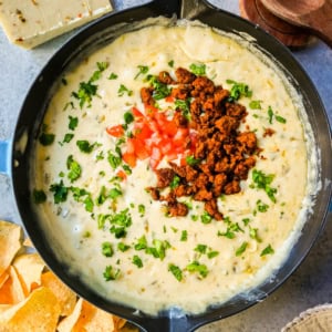 This creamy white queso dip is made with white American cheese, pepper jack, sautéed onion, garlic, and evaporated milk, it melts into the ultimate restaurant-style queso at home. The best rich easy queso recipe! I am sharing pro tips to keep it silky and never grainy.