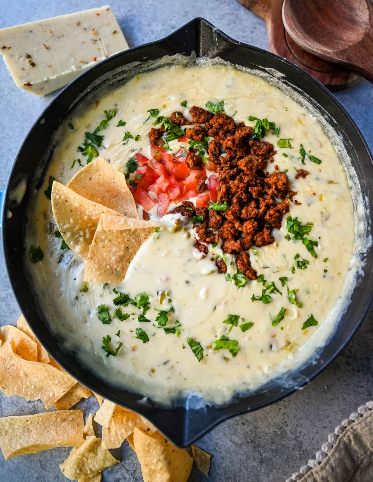 This creamy white queso dip is made with white American cheese, pepper jack, sautéed onion, garlic, and evaporated milk, it melts into the ultimate restaurant-style queso at home. The best rich easy queso recipe! I am sharing pro tips to keep it silky and never grainy.