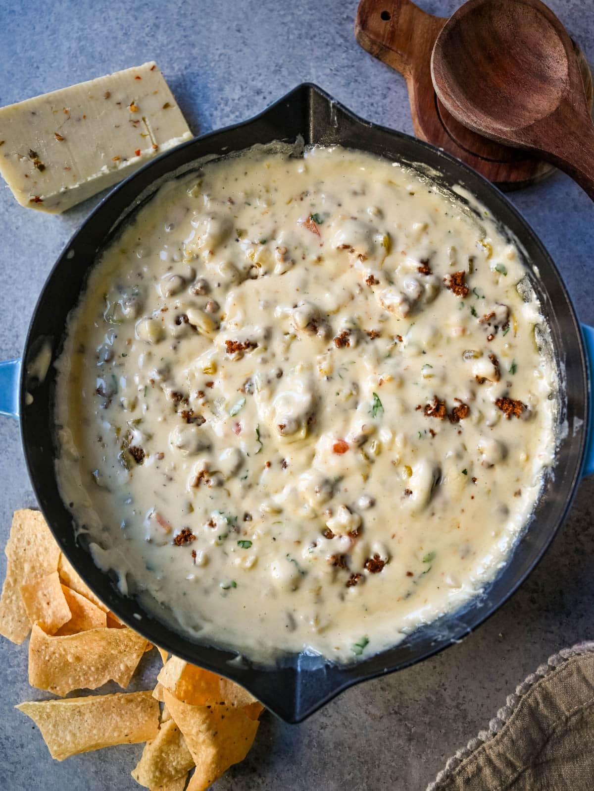 Homemade green chile queso with chorizo in skillet