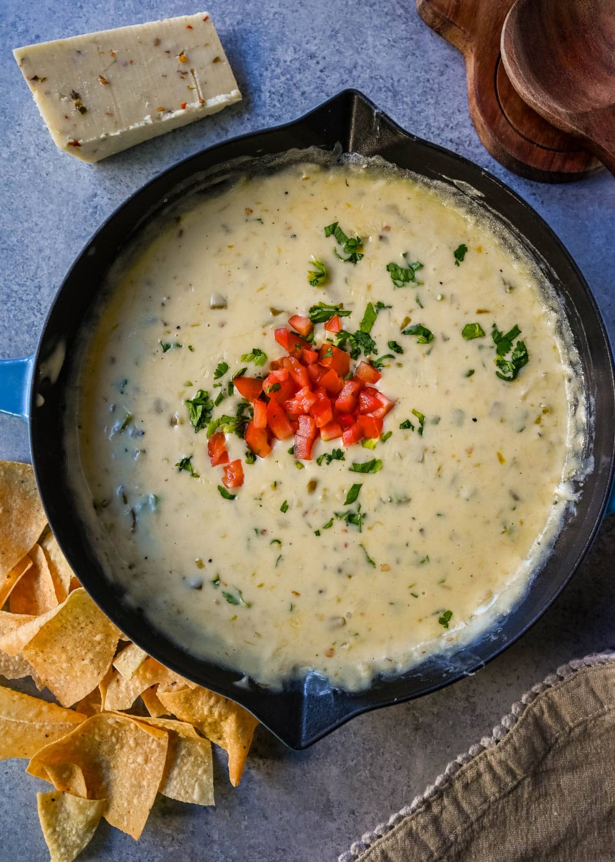 This creamy white queso dip is made with white American cheese, pepper jack, sautéed onion, garlic, and evaporated milk, it melts into the ultimate restaurant-style queso at home. The best rich easy queso recipe! I am sharing pro tips to keep it silky and never grainy.
