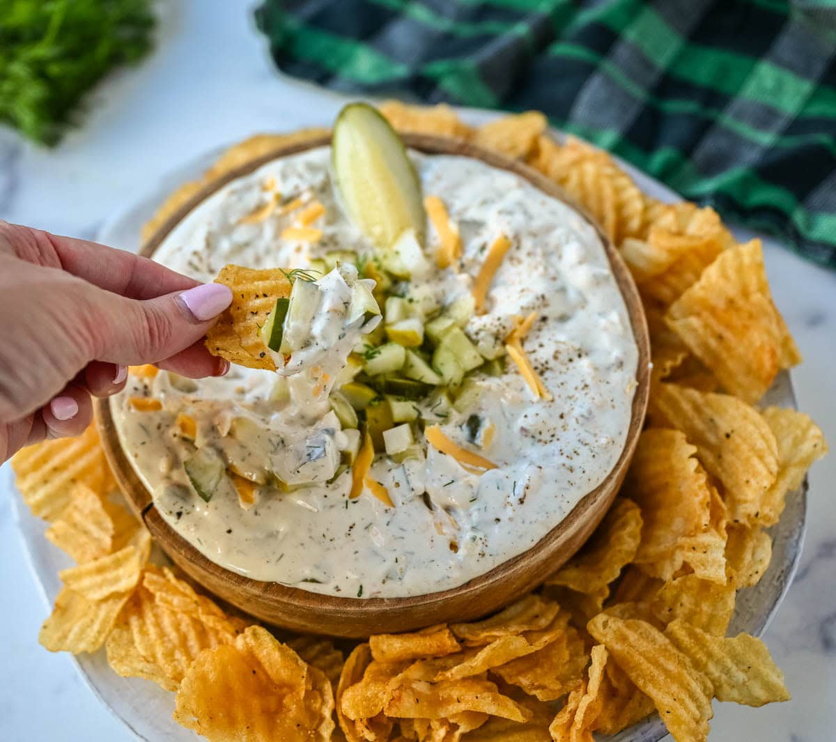 This Dill Pickle Dip is creamy, tangy, and the ultimate party dip for pickle lovers! Made with Greek yogurt, cream cheese, and sour cream for the perfect balance of creamy and zesty, it’s loaded with chopped dill pickles, fresh dill, sharp cheddar, and a touch of spice!