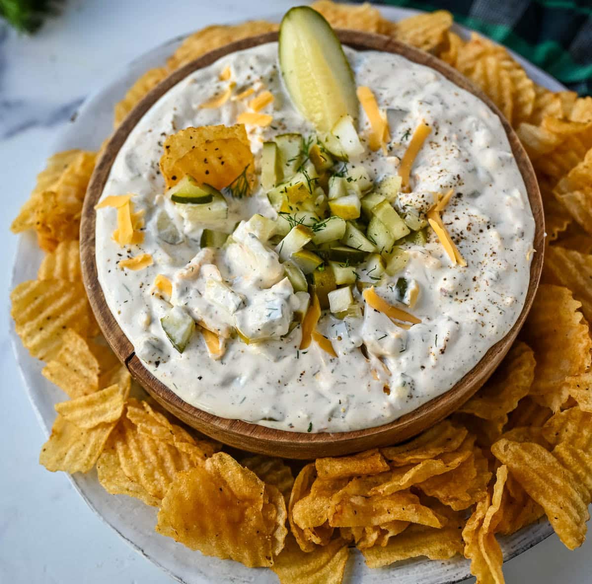 This Dill Pickle Dip is creamy, tangy, and the ultimate party dip for pickle lovers! Made with Greek yogurt, cream cheese, and sour cream for the perfect balance of creamy and zesty, it’s loaded with chopped dill pickles, fresh dill, sharp cheddar, and a touch of spice!
