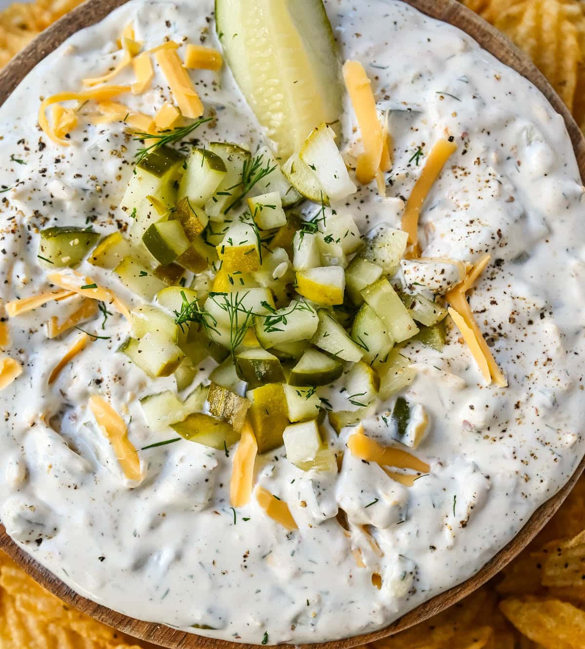 This Dill Pickle Dip is creamy, tangy, and the ultimate party dip for pickle lovers! Made with Greek yogurt, cream cheese, and sour cream for the perfect balance of creamy and zesty, it’s loaded with chopped dill pickles, fresh dill, sharp cheddar, and a touch of spice!