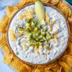 This Dill Pickle Dip is creamy, tangy, and the ultimate party dip for pickle lovers! Made with Greek yogurt, cream cheese, and sour cream for the perfect balance of creamy and zesty, it’s loaded with chopped dill pickles, fresh dill, sharp cheddar, and a touch of spice!