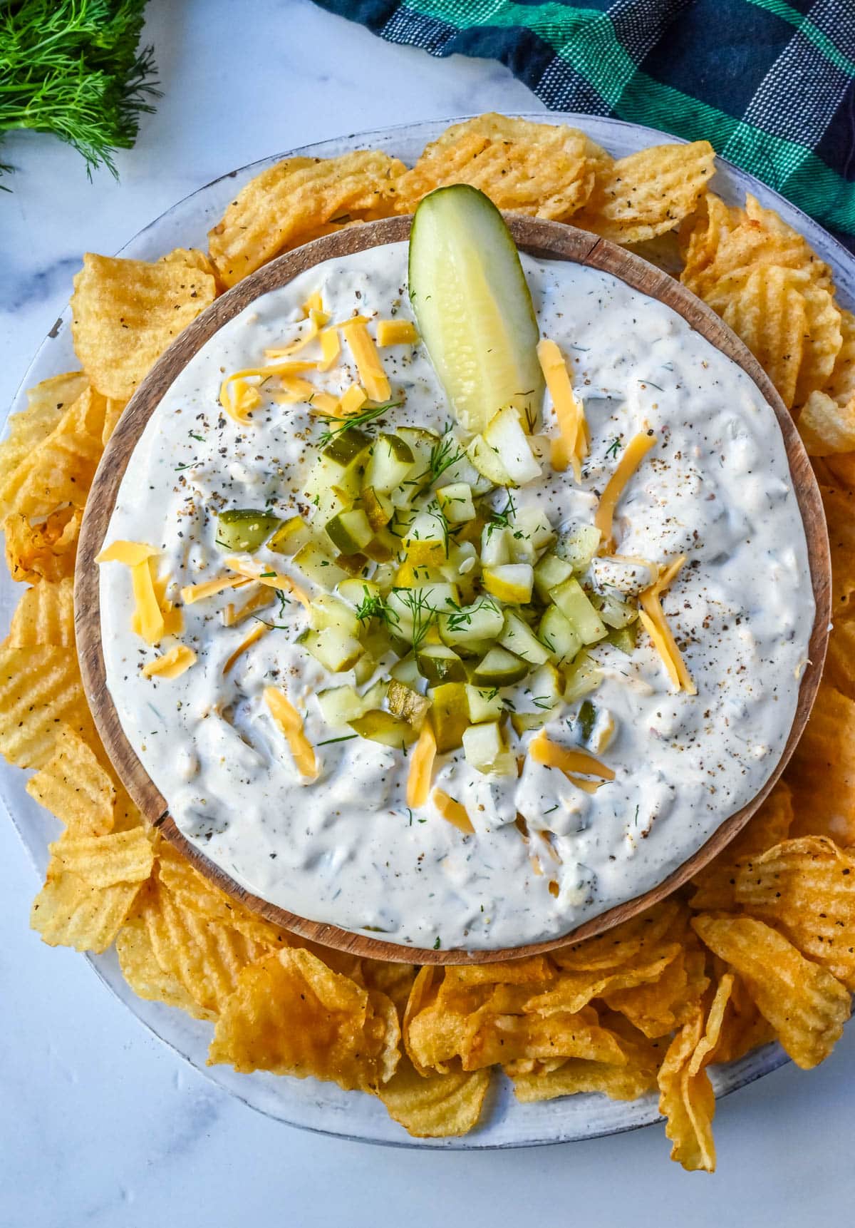 This Dill Pickle Dip is creamy, tangy, and the ultimate party dip for pickle lovers! Made with Greek yogurt, cream cheese, and sour cream for the perfect balance of creamy and zesty, it’s loaded with chopped dill pickles, fresh dill, sharp cheddar, and a touch of spice!