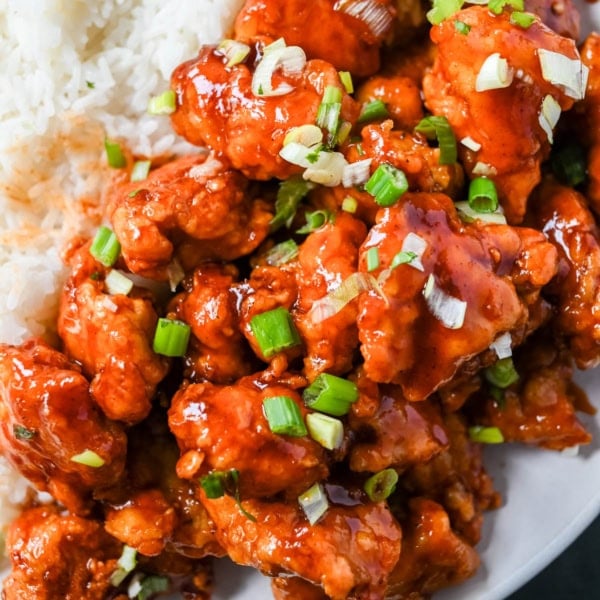 This homemade Honey Sriracha Chicken features tender chicken pieces fried until crispy and covered in a sticky honey sriracha glaze. The combination of honey, garlic, soy sauce, and sriracha creates the ultimate sweet heat flavor. This sticky chicken is way better than takeout!