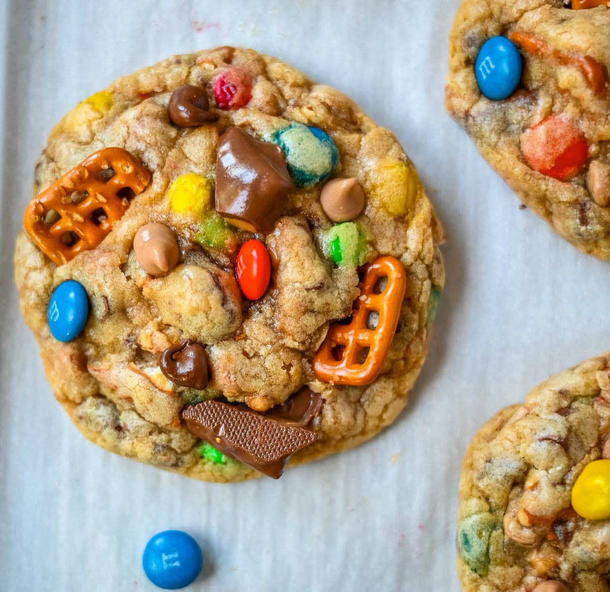 These Kitchen Sink Cookies are thick, soft, and chewy bakery-style cookies packed with chocolate chips, colorful M&M’s, crunchy pretzels, buttery toffee bits, and gooey caramel or peanut butter chips. Every bite is sweet, salty, crunchy, and chocolatey all at once. They’re called “kitchen sink” cookies because you can throw in everything but the kitchen sink, making them one of the most versatile and fully loaded cookie recipes you’ll ever bake.