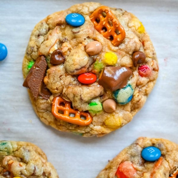 These Kitchen Sink Cookies are thick, soft, and chewy bakery-style cookies packed with chocolate chips, colorful M&M’s, crunchy pretzels, buttery toffee bits, and gooey caramel or peanut butter chips. Every bite is sweet, salty, crunchy, and chocolatey all at once. They’re called “kitchen sink” cookies because you can throw in everything but the kitchen sink, making them one of the most versatile and fully loaded cookie recipes you’ll ever bake.