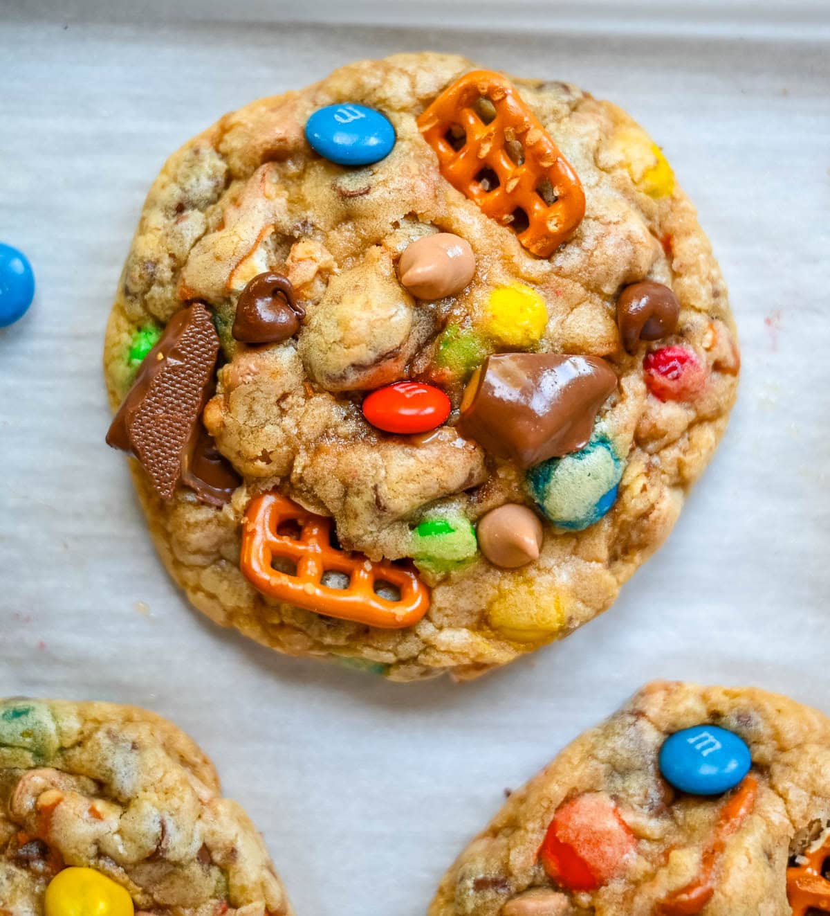 These Kitchen Sink Cookies are thick, soft, and chewy bakery-style cookies packed with chocolate chips, colorful M&M’s, crunchy pretzels, buttery toffee bits, and gooey caramel or peanut butter chips. Every bite is sweet, salty, crunchy, and chocolatey all at once. They’re called “kitchen sink” cookies because you can throw in everything but the kitchen sink, making them one of the most versatile and fully loaded cookie recipes you’ll ever bake.