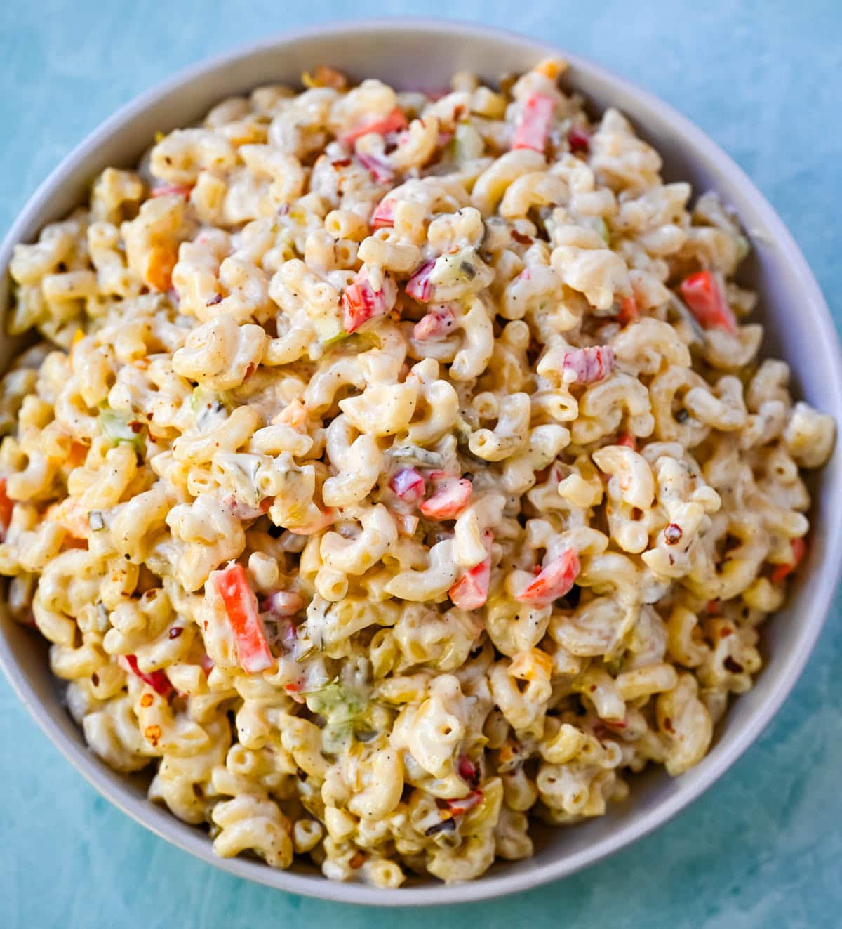 Tired of dry or bland macaroni salad? This creamy macaroni salad recipe is always a huge hit! Learn how to make the best creamy macaroni salad with this easy homemade recipe. Packed with crunchy vegetables, a rich mayo and sour cream dressing, and perfectly cooked pasta, this classic macaroni salad is always a crowd favorite.
