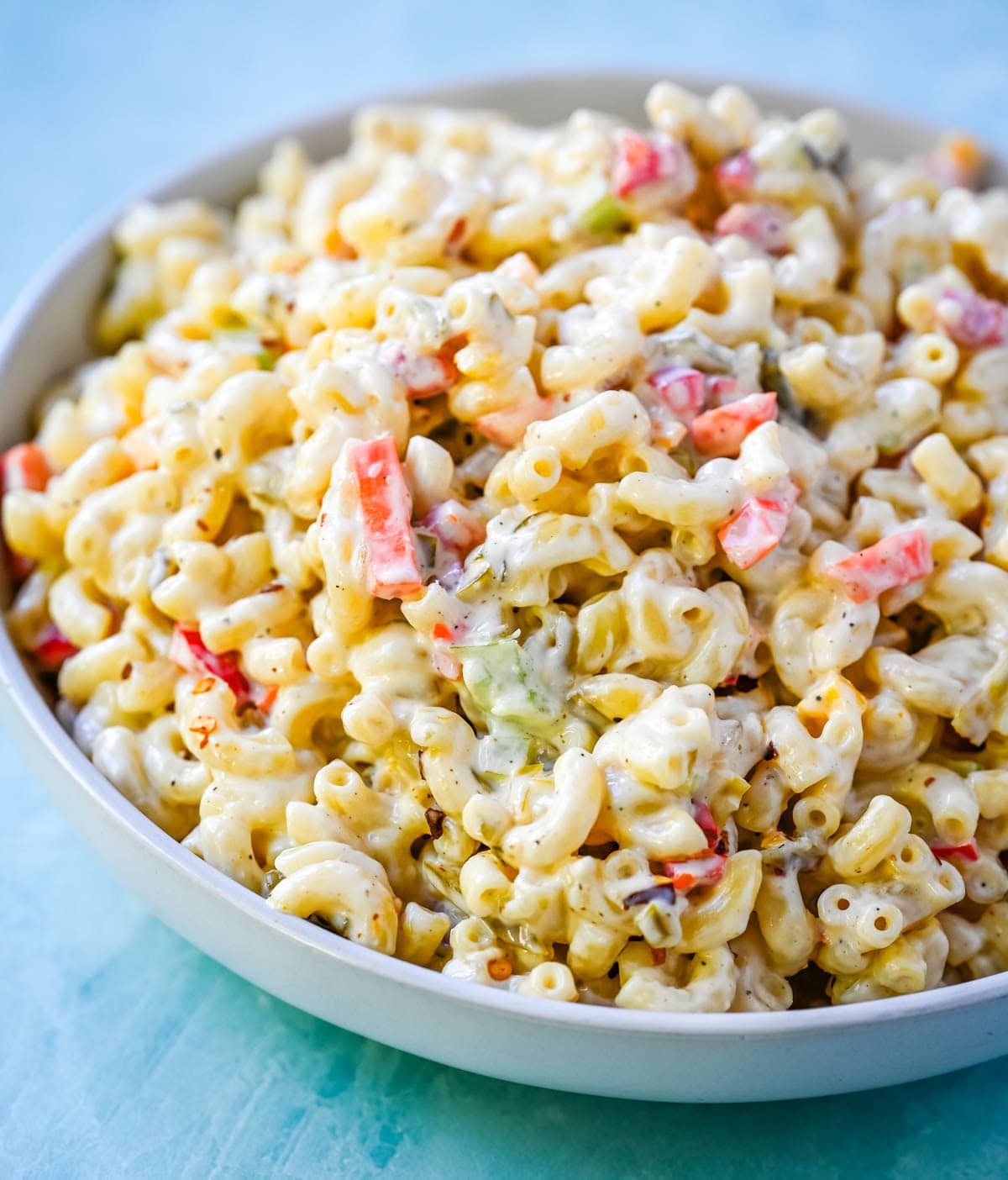 Tired of dry or bland macaroni salad? This creamy macaroni salad recipe is always a huge hit! Learn how to make the best creamy macaroni salad with this easy homemade recipe. Packed with crunchy vegetables, a rich mayo and sour cream dressing, and perfectly cooked pasta, this classic macaroni salad is always a crowd favorite.