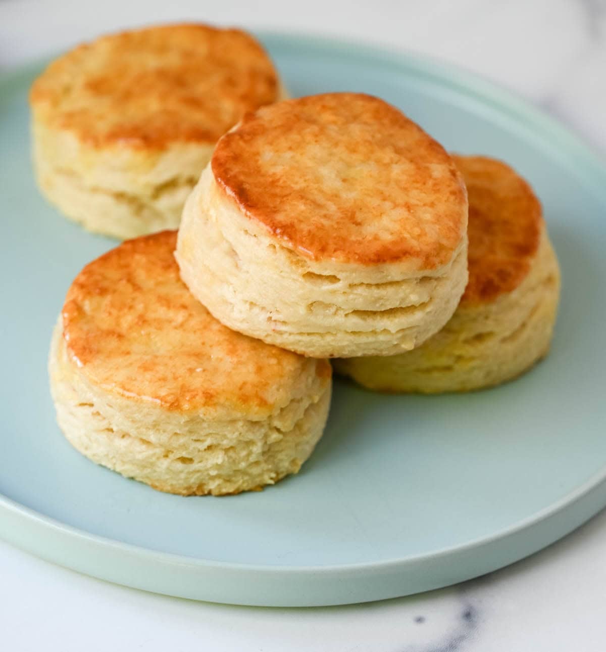 These classic buttermilk biscuits are soft, flaky, and rich with buttery flavor. Each biscuit rises tall in the oven, creating delicate layers with a crisp, golden exterior and a tender, airy interior. This easy biscuit recipe uses 6 simple ingredients and has the perfect texture without complicated steps. It’s a classic homemade biscuit recipe that everyone loves.