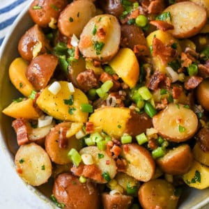 This no mayo potato salad is the perfect summer side dish -- light, tangy, and packed with fresh herbs. Made with a simple olive oil and vinegar dressing, this vinaigrette-based potato salad soaks into tender potatoes for incredible flavor without the heaviness of mayonnaise. Inspired by classic German potato salad, this version is fresh and healthy. If you’re looking for a potato salad without mayonnaise that’s full of flavor, this is the one for you!