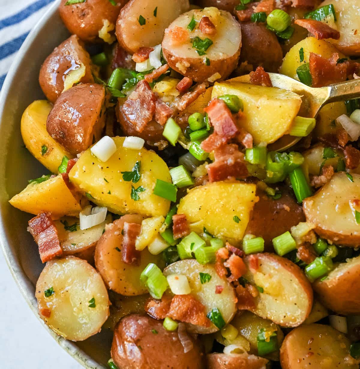 This no mayo potato salad is the perfect summer side dish -- light, tangy, and packed with fresh herbs. Made with a simple olive oil and vinegar dressing, this vinaigrette-based potato salad soaks into tender potatoes for incredible flavor without the heaviness of mayonnaise. Inspired by classic German potato salad, this version is fresh and healthy. If you’re looking for a potato salad without mayonnaise that’s full of flavor, this is the one for you!