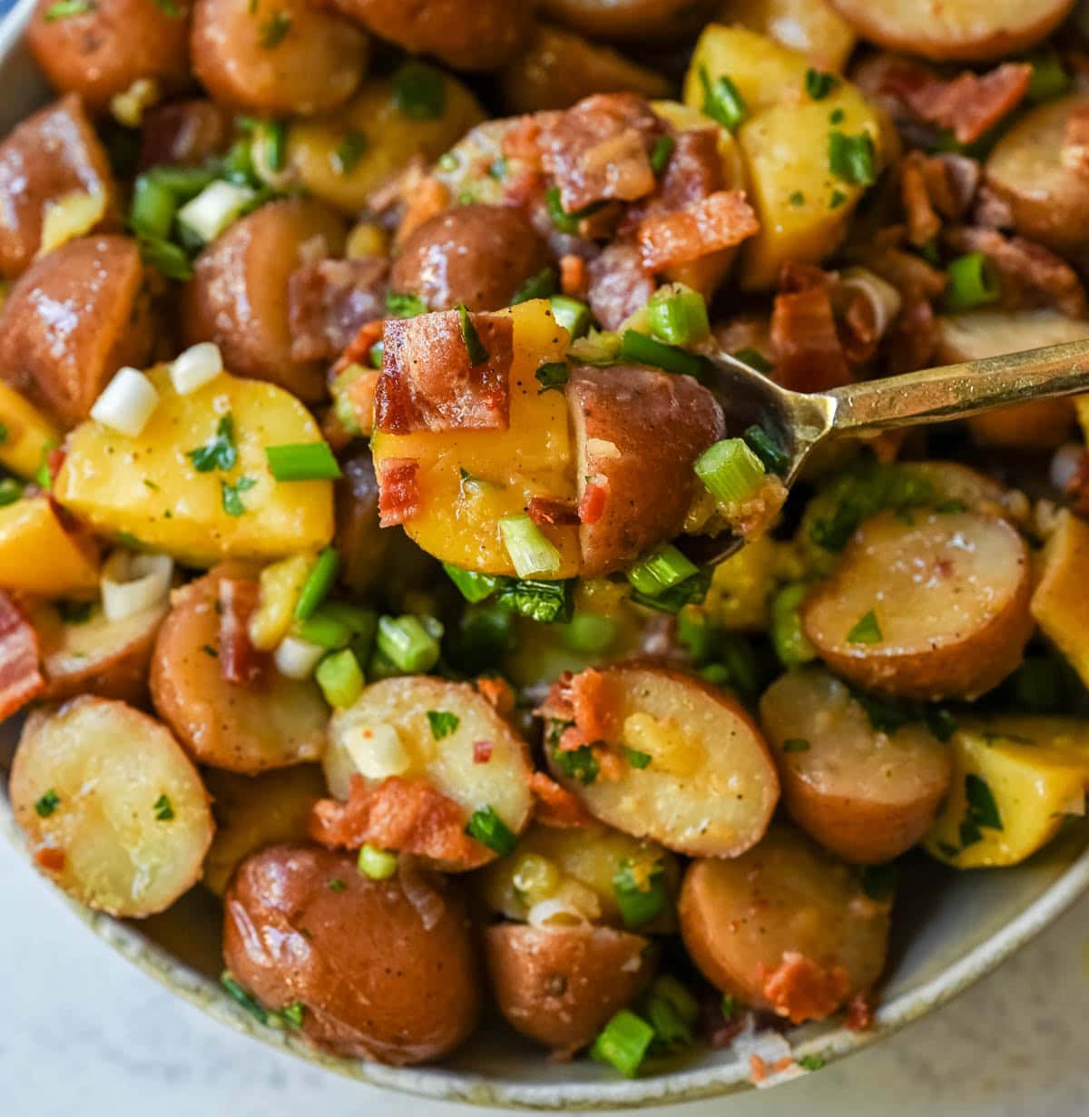 This no mayo potato salad is the perfect summer side dish -- light, tangy, and packed with fresh herbs. Made with a simple olive oil and vinegar dressing, this vinaigrette-based potato salad soaks into tender potatoes for incredible flavor without the heaviness of mayonnaise. Inspired by classic German potato salad, this version is fresh and healthy. If you’re looking for a potato salad without mayonnaise that’s full of flavor, this is the one for you!