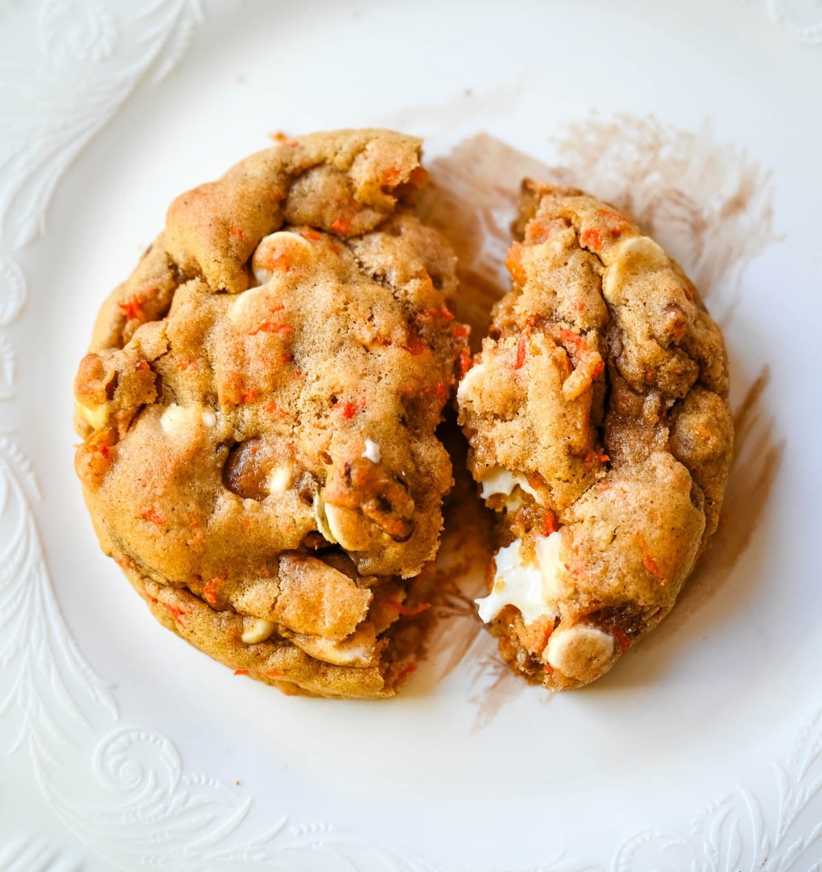 These Levain Bakery Carrot Cake Cookies are everything you love about carrot cake in a soft, thick cookie. Made with shredded carrots, warm spices, white chocolate chips, dried apricots and pecans, they are rich, flavorful, and perfectly chewy. A delicious spring dessert that’s easy to make at home!