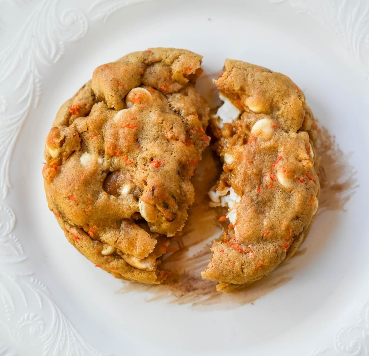 These Levain Bakery Carrot Cake Cookies are everything you love about carrot cake in a soft, thick cookie. Made with shredded carrots, warm spices, white chocolate chips, dried apricots and pecans, they are rich, flavorful, and perfectly chewy. A delicious spring dessert that’s easy to make at home!