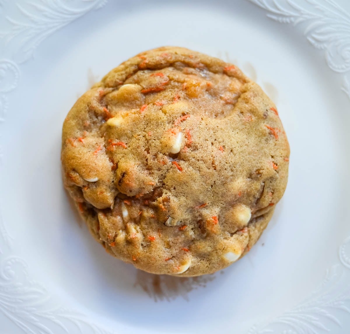 These Levain Bakery Carrot Cake Cookies are everything you love about carrot cake in a soft, thick cookie. Made with shredded carrots, warm spices, white chocolate chips, dried apricots and pecans, they are rich, flavorful, and perfectly chewy. A delicious spring dessert that’s easy to make at home!