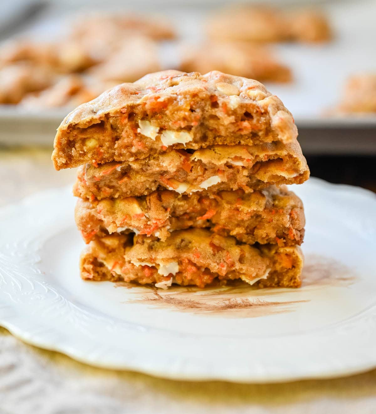 These Levain Bakery Carrot Cake Cookies are everything you love about carrot cake in a soft, thick cookie. Made with shredded carrots, warm spices, white chocolate chips, dried apricots and pecans, they are rich, flavorful, and perfectly chewy. A delicious spring dessert that’s easy to make at home!