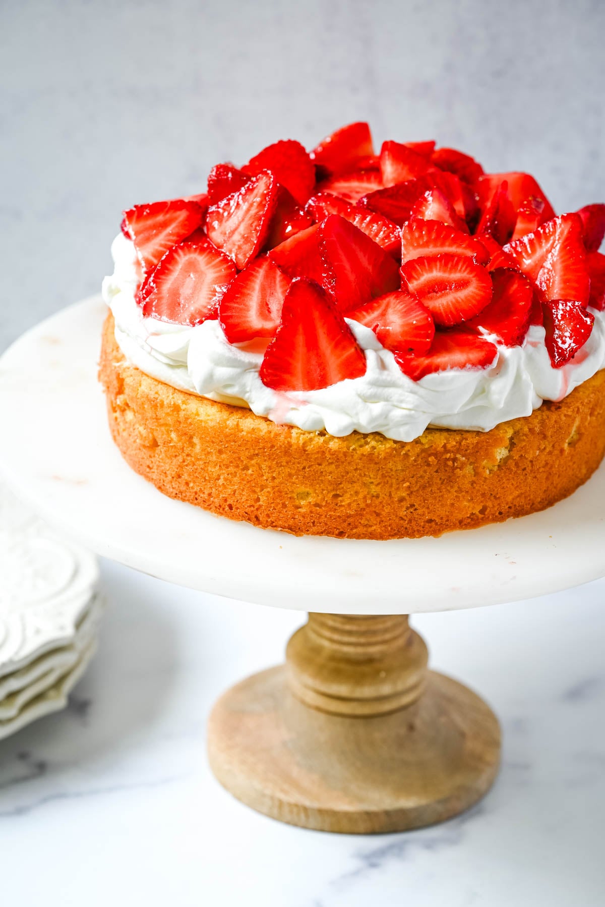 This Strawberry Shortcake Cake is a soft, buttery vanilla cake layered with fluffy homemade whipped cream and juicy strawberries. It’s the perfect spring and summer dessert that tastes like a classic strawberry shortcake but in an easy-to-slice cake form.