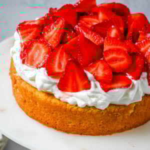 This Strawberry Shortcake Cake is a soft, buttery vanilla cake layered with fluffy homemade whipped cream and juicy strawberries. It’s the perfect spring and summer dessert that tastes like a classic strawberry shortcake but in an easy-to-slice cake form.