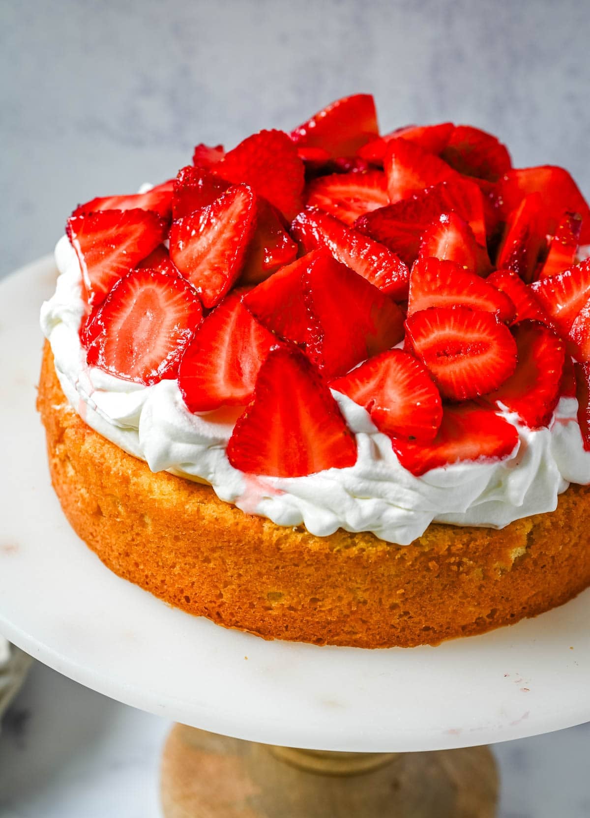 This Strawberry Shortcake Cake is a soft, buttery vanilla cake layered with fluffy homemade whipped cream and juicy strawberries. It’s the perfect spring and summer dessert that tastes like a classic strawberry shortcake but in an easy-to-slice cake form.
