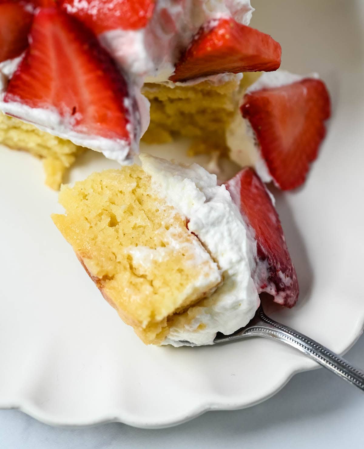 This Strawberry Shortcake Cake is a soft, buttery vanilla cake layered with fluffy homemade whipped cream and juicy strawberries. It’s the perfect spring and summer dessert that tastes like a classic strawberry shortcake but in an easy-to-slice cake form.