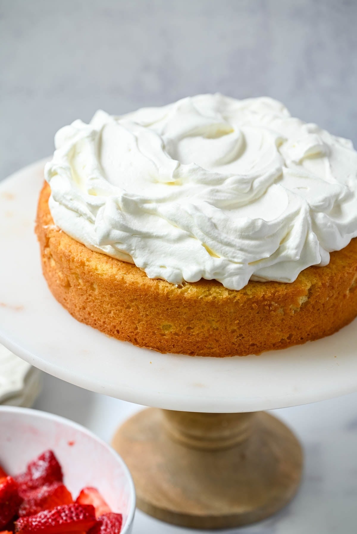 Spread whipped cream all over cake