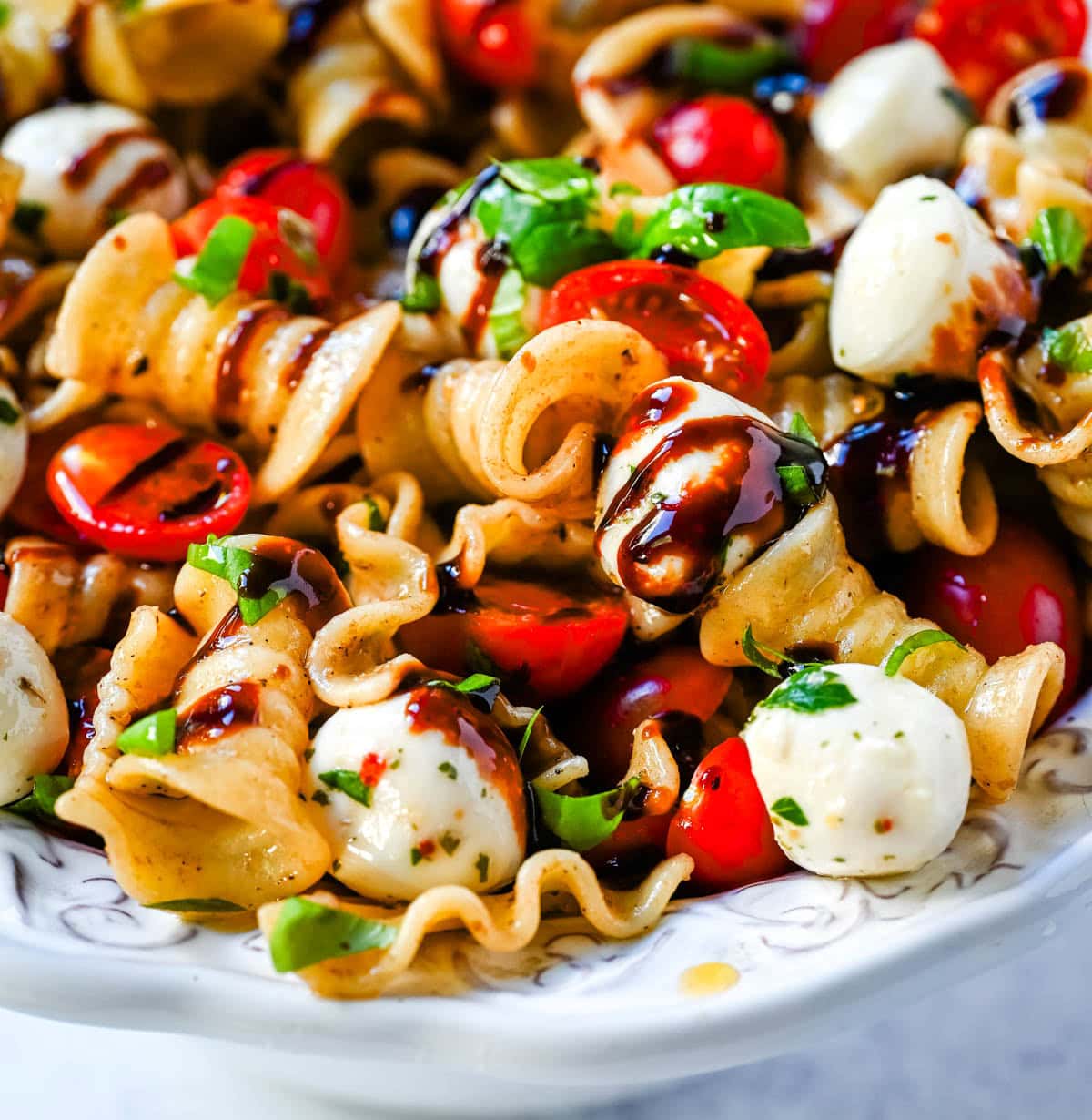 This Caprese pasta salad is a fresh, easy summer pasta salad loaded with juicy tomatoes, creamy mozzarella, and fresh basil. Tossed with olive oil and balsamic or a simple Italian dressing, it’s a light yet flavorful dish that comes together in minutes.